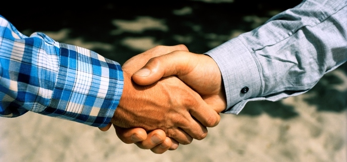Two persons shaking hands